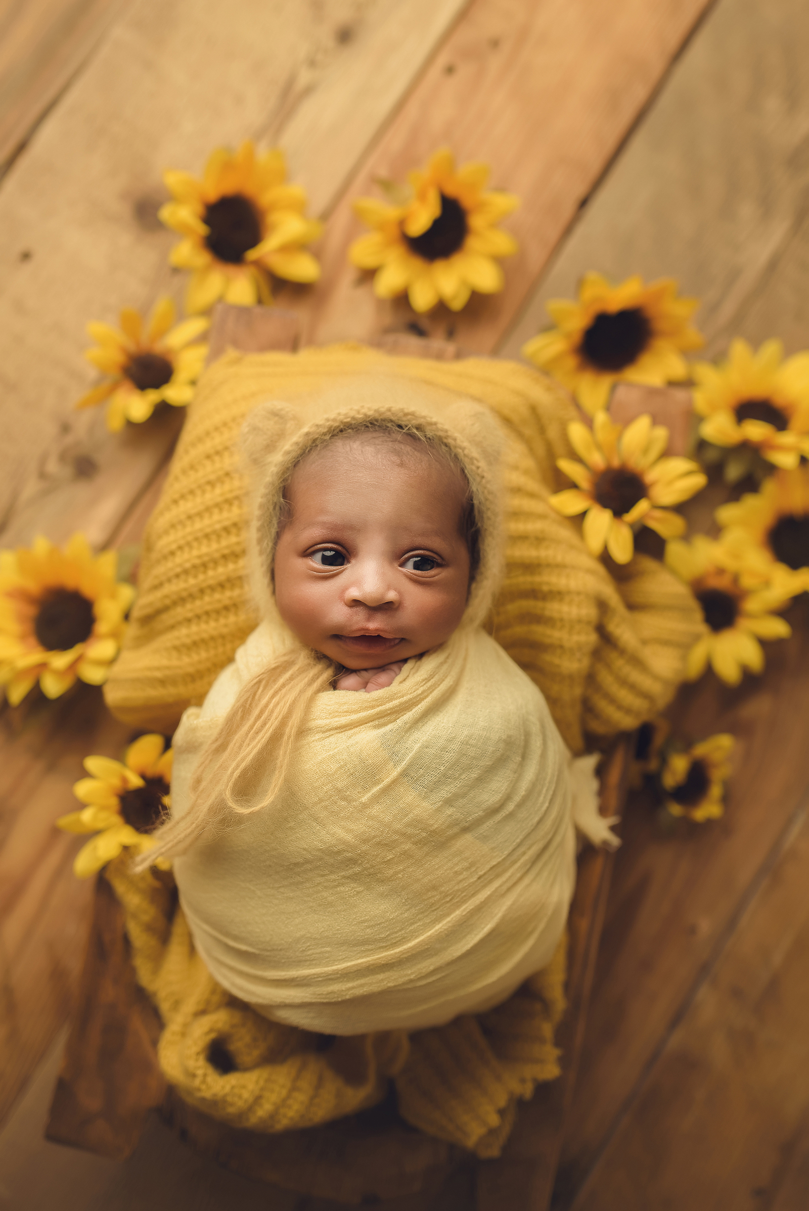 newborn with sunflowers