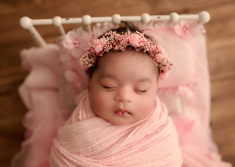 Baby girl in blush pink wrap with matching headband