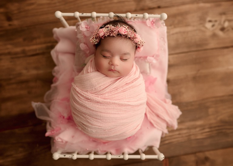 Baby wrapped up in soft blanket, sleeping peacefully in Frisco TX