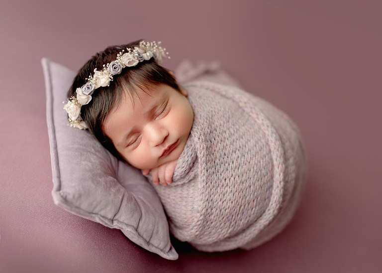 Professional newborn photographer in Allen TX capturing cozy lifestyle portraits of baby girl