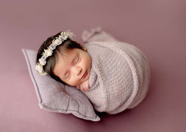 Professional newborn photographer in Allen TX capturing cozy lifestyle portraits of baby girl