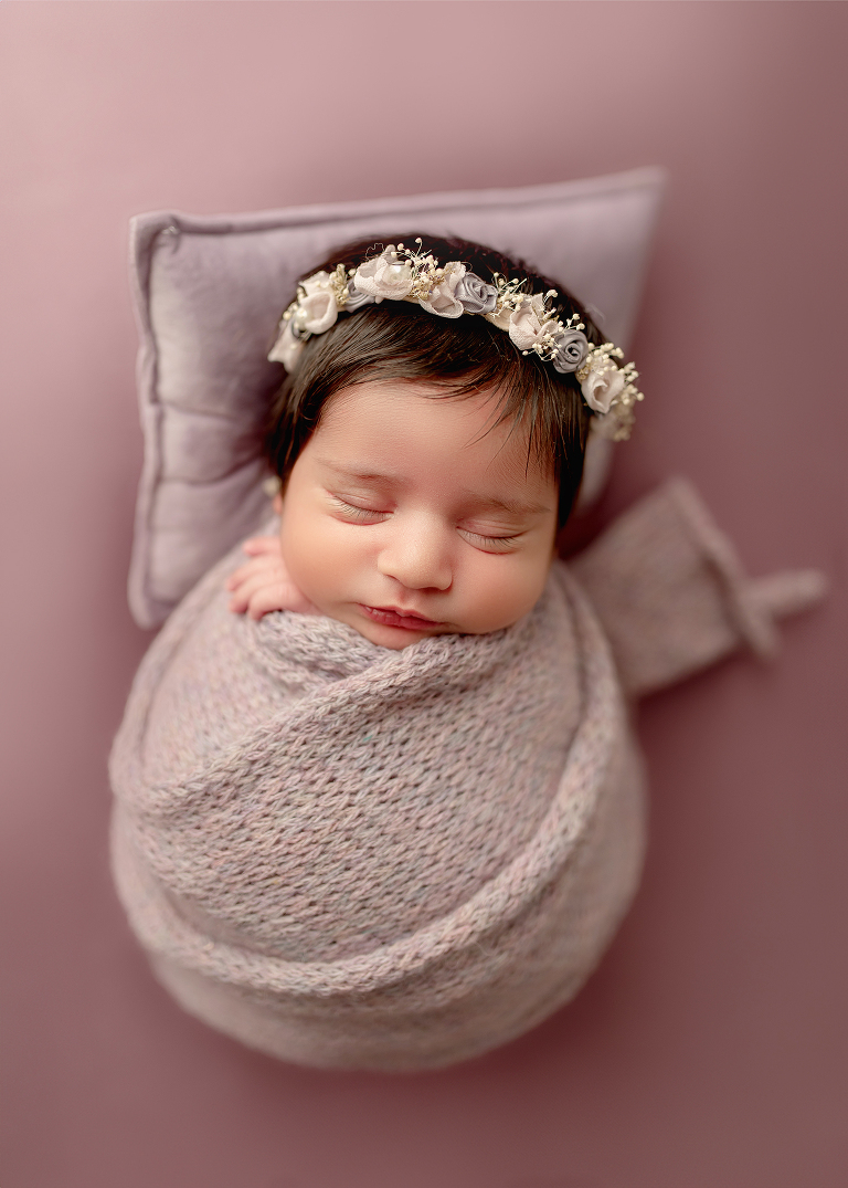 Professional newborn photographer in Allen TX capturing cozy lifestyle portraits of baby girl
